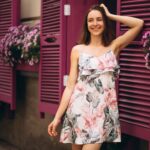 portrait-happy-woman-outside-cafe-decorated-with-flowers